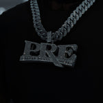 Person wearing a black sweatshirt with 'PRE' text and a large chain necklace.